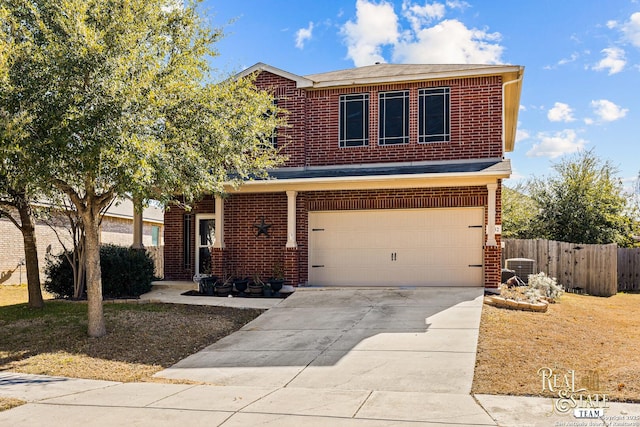 traditional-style home featuring a garage, concrete driveway, brick siding, and fence