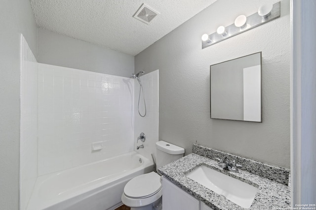 full bathroom with vanity, toilet, shower / washtub combination, and a textured ceiling