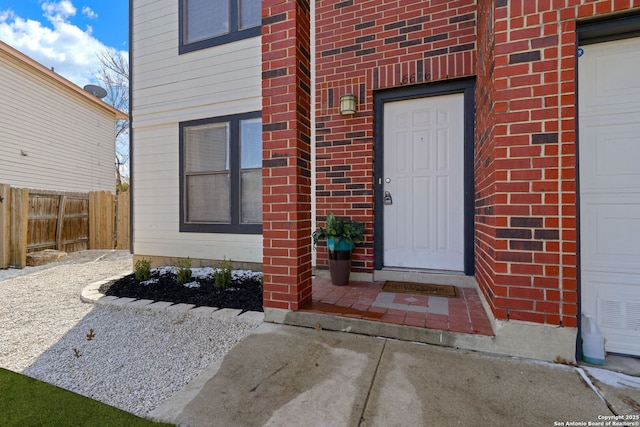 view of exterior entry with a garage