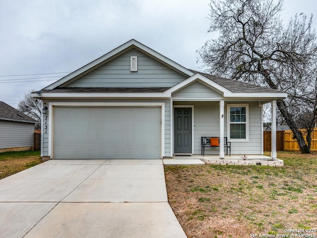 view of front of property with a front yard, a porch, and a garage