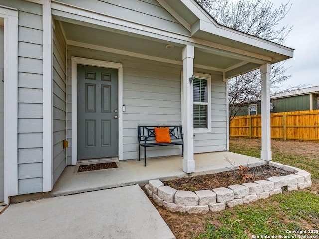 view of exterior entry with covered porch