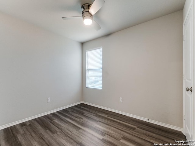 empty room with dark hardwood / wood-style floors and ceiling fan