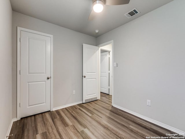 unfurnished bedroom featuring light wood-type flooring and ceiling fan