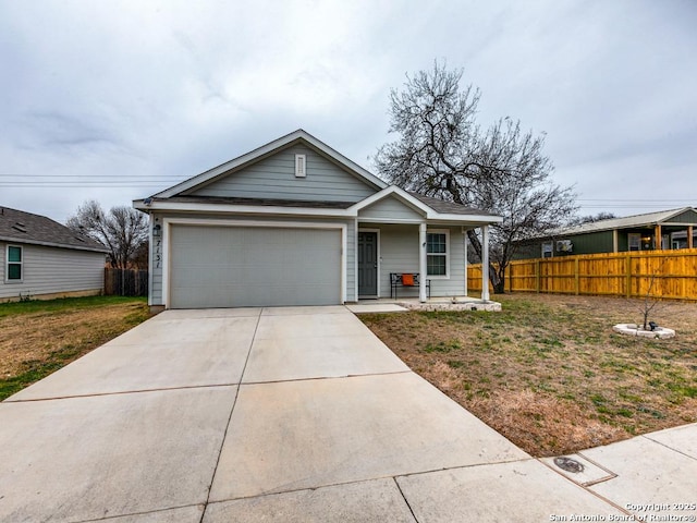 view of front of property with a front yard and a garage