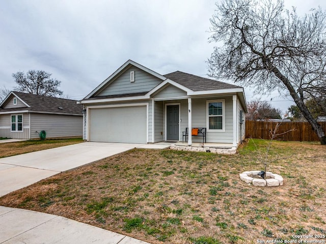 view of front of home with covered porch, a front yard, and a garage