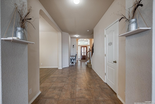 hallway featuring a textured ceiling