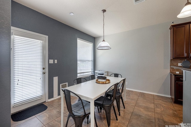 dining area with light tile patterned floors