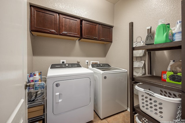 laundry area with cabinets and washer and clothes dryer