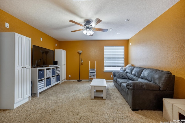 living room featuring light carpet, a textured ceiling, and ceiling fan