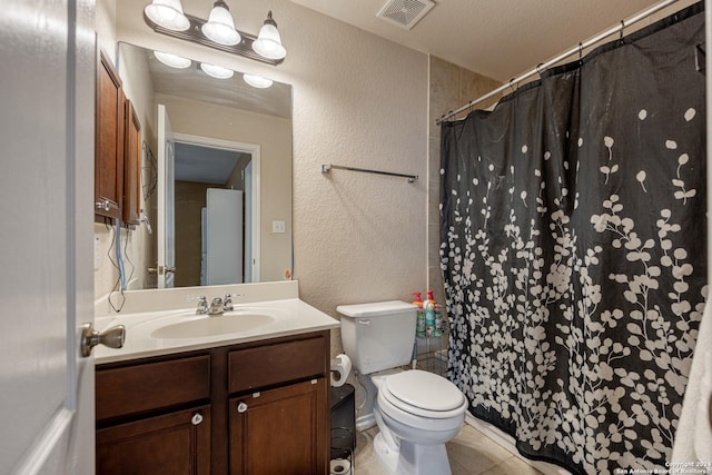 bathroom with vanity, toilet, curtained shower, and a textured ceiling