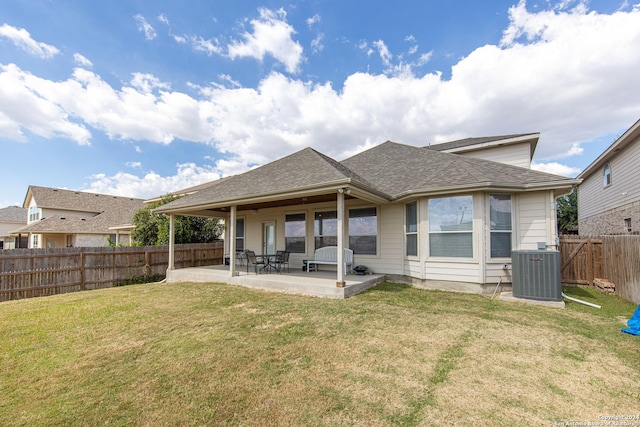 back of property with a lawn, central AC, and a patio