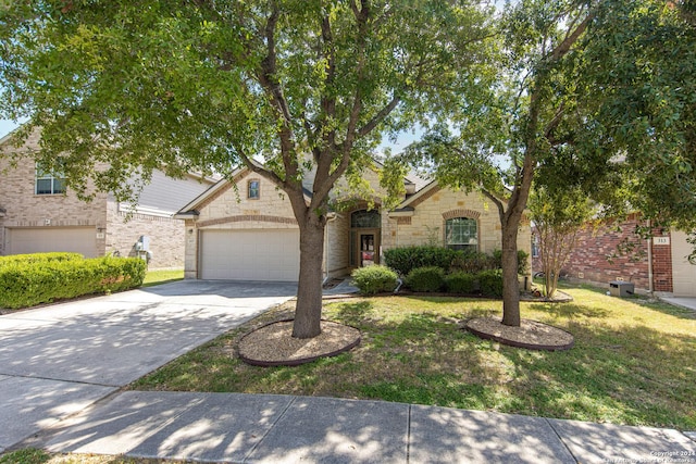 view of front of house featuring a front yard and a garage