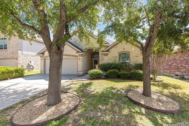 ranch-style home featuring a garage and a front lawn