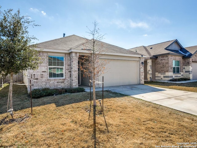 single story home with a garage and a front lawn