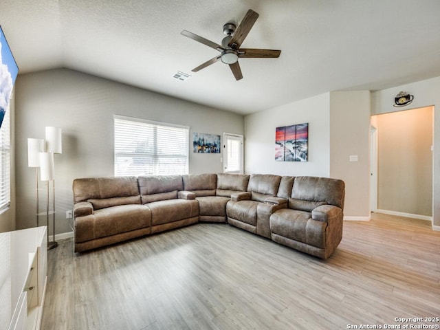 living room with light hardwood / wood-style floors, lofted ceiling, and ceiling fan