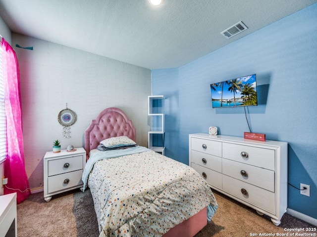 bedroom with carpet flooring and a textured ceiling