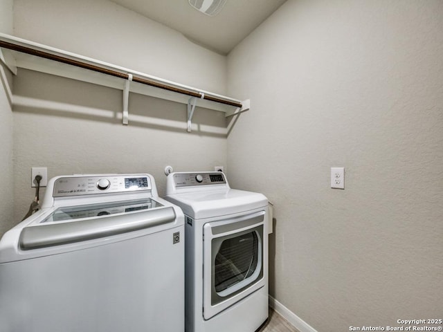 laundry room featuring separate washer and dryer