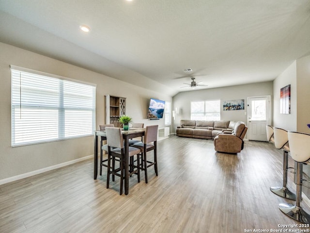 dining area with lofted ceiling, light wood-type flooring, and ceiling fan