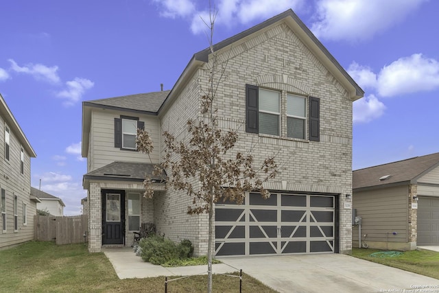 front facade featuring a front yard and a garage