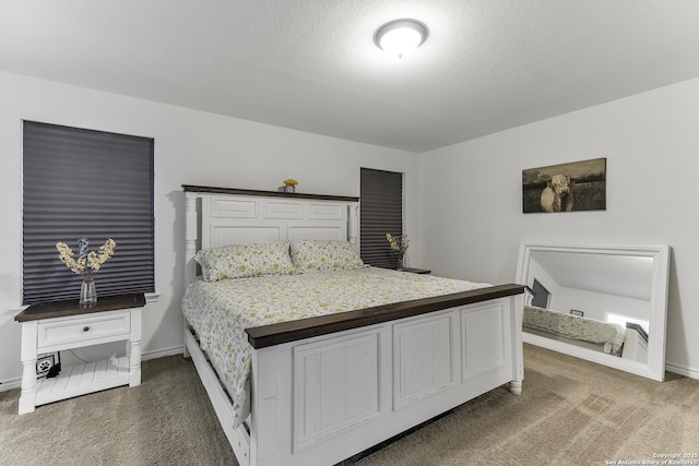 bedroom featuring dark carpet and a textured ceiling