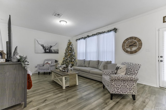 living room featuring crown molding and hardwood / wood-style flooring