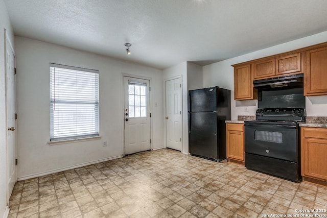 kitchen featuring black appliances and a textured ceiling