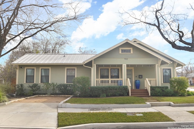 view of front of property with a front yard and a porch