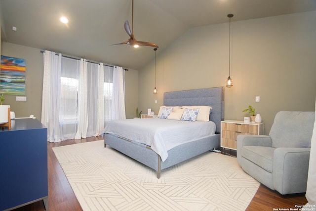 bedroom with ceiling fan, hardwood / wood-style floors, and vaulted ceiling