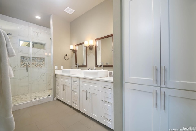 bathroom featuring a shower with door, tile patterned floors, and vanity