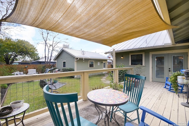 wooden terrace featuring a lawn