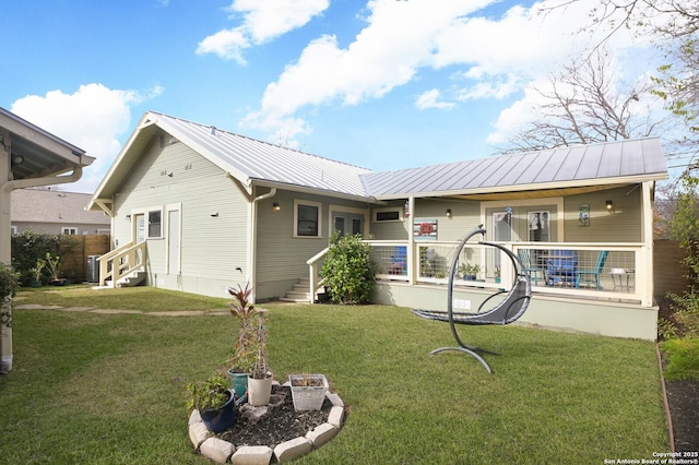 rear view of property featuring a yard