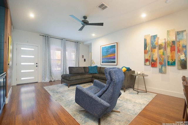 living room featuring dark hardwood / wood-style floors and ceiling fan