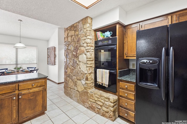 kitchen with pendant lighting, a textured ceiling, black appliances, dark stone counters, and light tile patterned floors