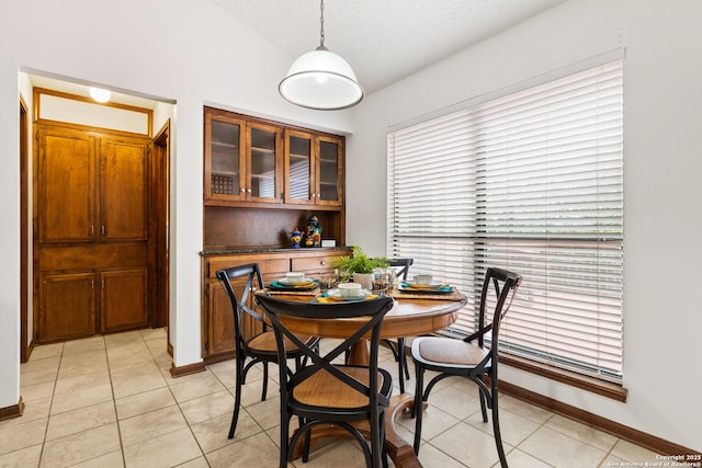 tiled dining room with a textured ceiling