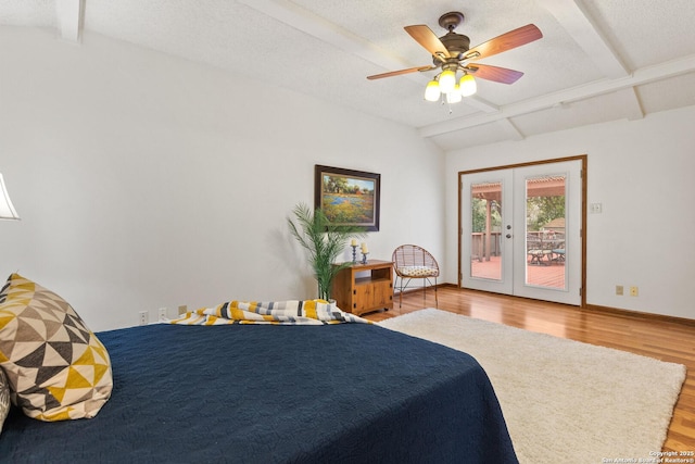 bedroom featuring wood-type flooring, ceiling fan, french doors, access to exterior, and beamed ceiling