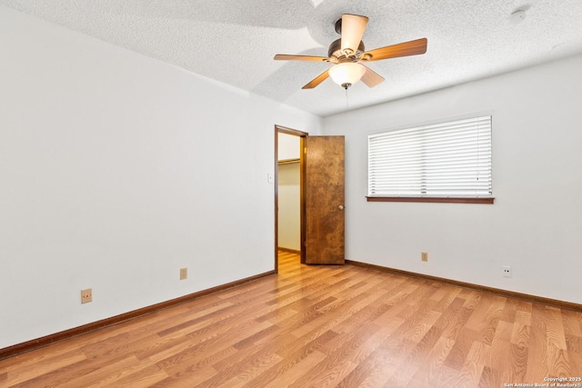 unfurnished room with light hardwood / wood-style floors, a textured ceiling, and ceiling fan