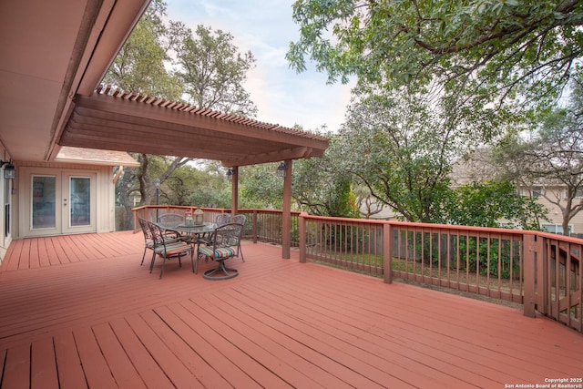 wooden deck featuring french doors and a pergola