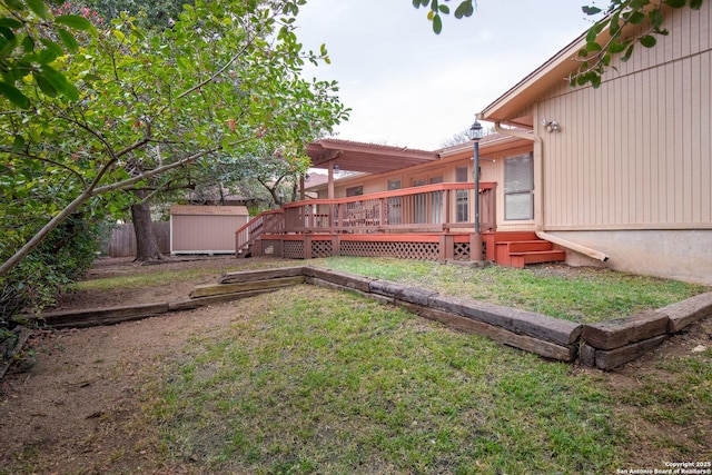 view of yard featuring a deck and a shed