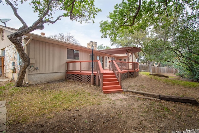 back of property featuring a pergola and a wooden deck