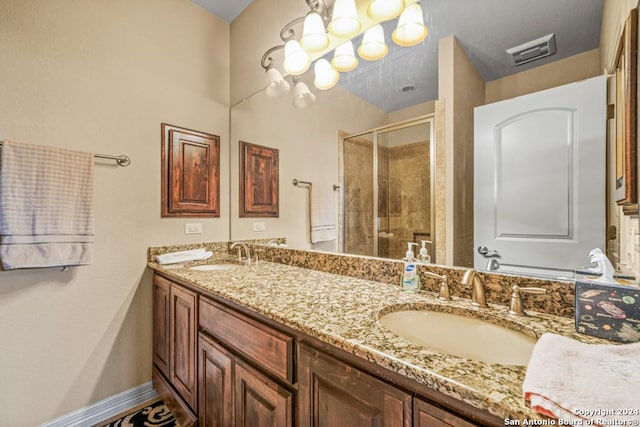 bathroom featuring vanity and a shower with shower door