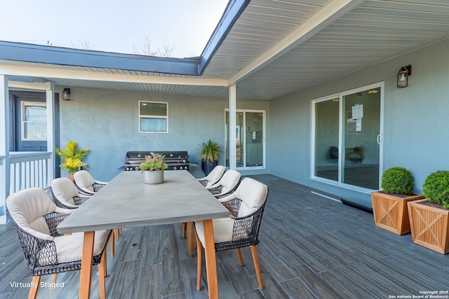 wooden terrace with a grill