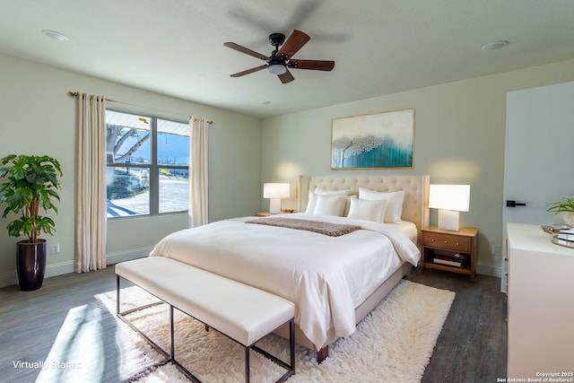 bedroom with ceiling fan and dark hardwood / wood-style flooring