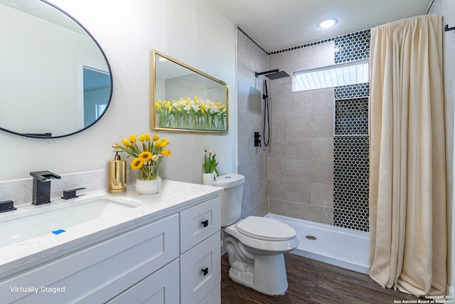 bathroom featuring wood-type flooring, a shower with curtain, toilet, and vanity