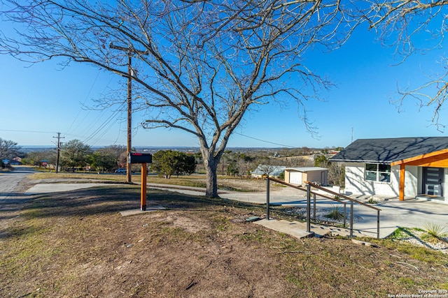 view of yard with a patio area and a storage shed