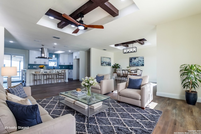 living room with ceiling fan, dark hardwood / wood-style flooring, and beamed ceiling