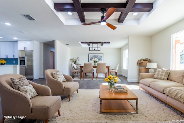 living room with coffered ceiling, beamed ceiling, ceiling fan, and light hardwood / wood-style floors