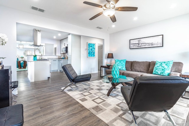 living room featuring hardwood / wood-style flooring and ceiling fan