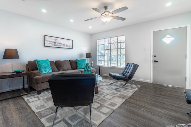 living room with ceiling fan and dark hardwood / wood-style flooring