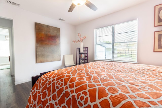 bedroom with ceiling fan and dark wood-type flooring