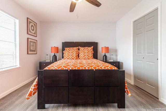 bedroom with ceiling fan, hardwood / wood-style flooring, and a closet